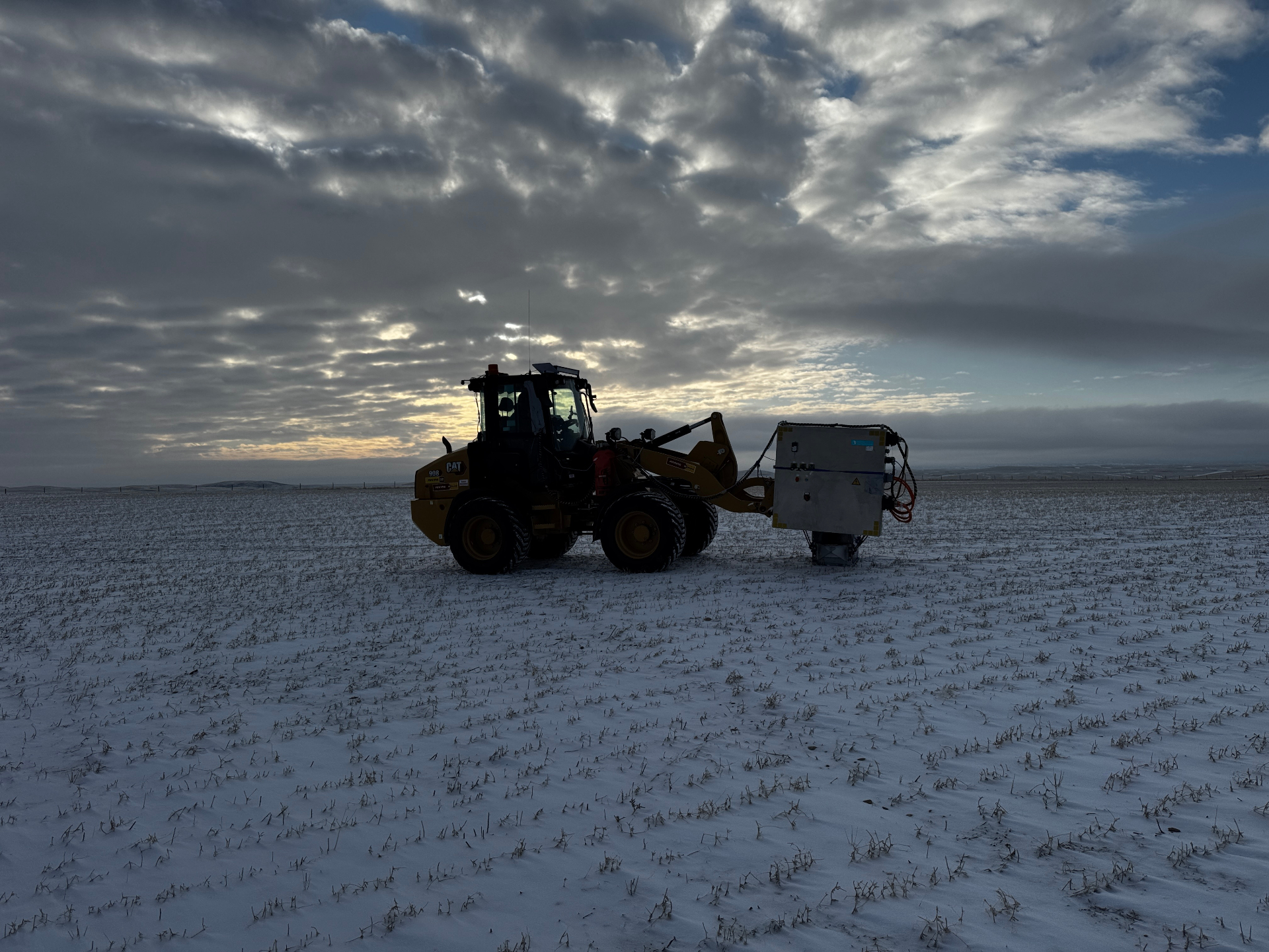 Aerial view of a seismic acquisition spread crossing snowy boreal forest at dawn